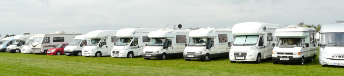 Motorhomes parked in a field