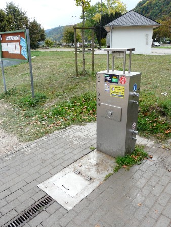 A fairly typical German motorhome service point - toilet waste under the metal flap, waste water down the drain and fresh water from the tap at the side (toilet rinsing water from a different tap, lower down)