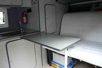 Rock and roll bed in seating position with table