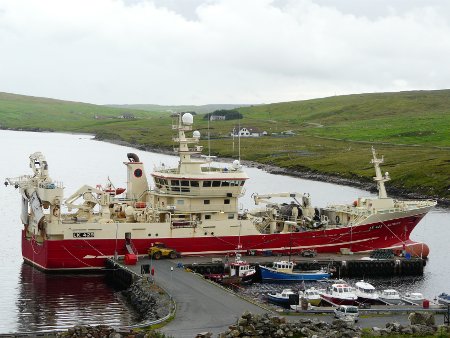 Large fishing boat in small Shetland harbour